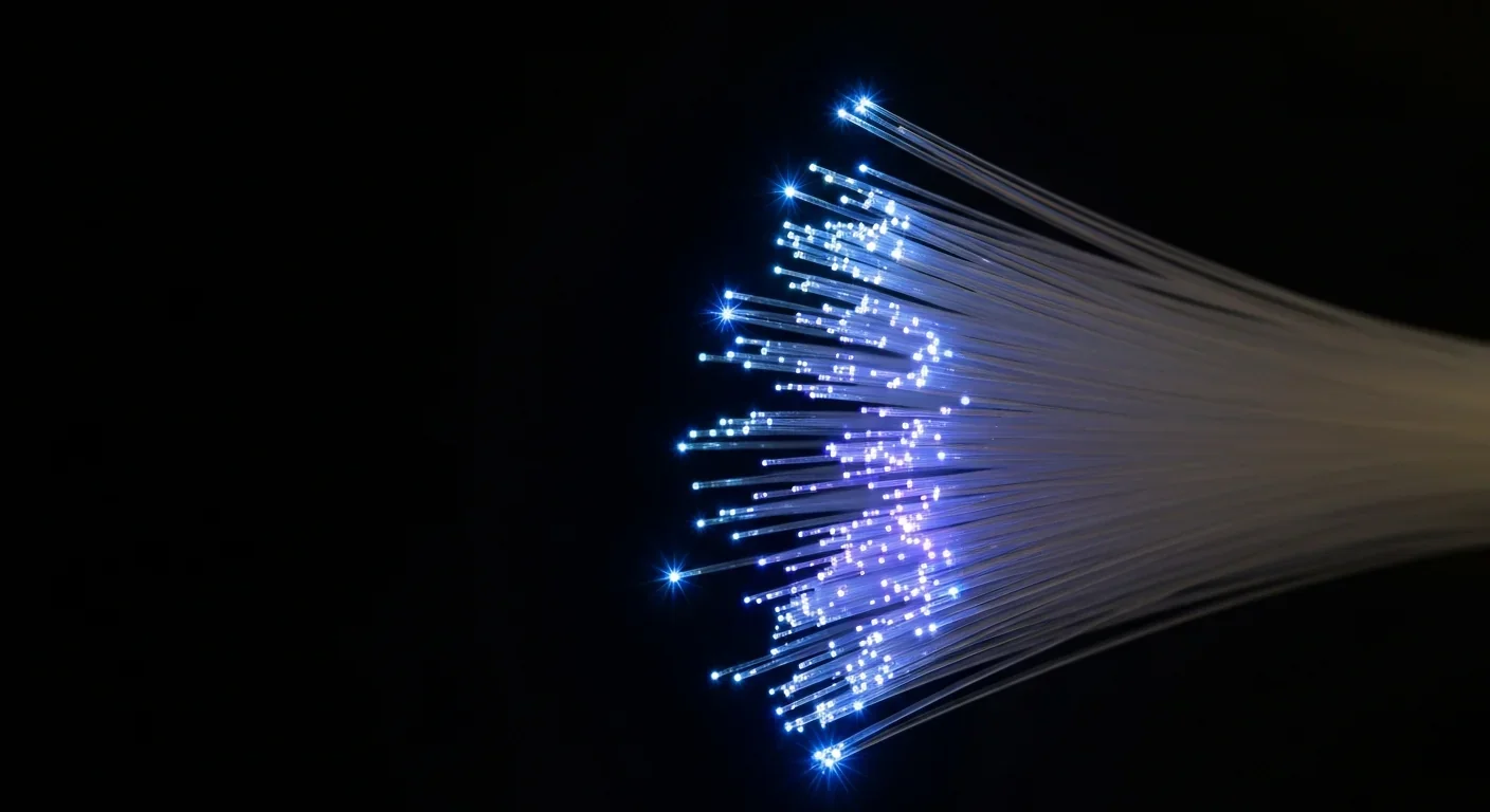 Fiber optic cable bundle with bright light points at the ends against a dark background